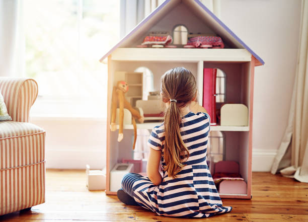 istock She breaths life into her dollhouse 868951658
