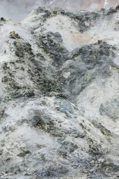 Photo of Close up detail of Noboribetsu Jigokudani (Hell Valley): The volcano valley got its name from the sulfuric smell, extremely high heat and steam spouting out of the ground in Hokkaido, Japan.