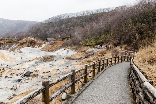 Walk way of Noboribetsu Jigokudani (Hell Valley): The volcano valley got its name from the sulfuric smell, extremely high heat and steam spouting out of the ground in Hokkaido, Japan.