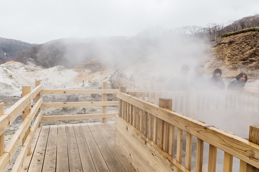 Wooden walk way near hot spring at Noboribetsu Jigokudani (Hell Valley): The volcano valley got its name from the sulfuric smell in Hokkaido, Japan.