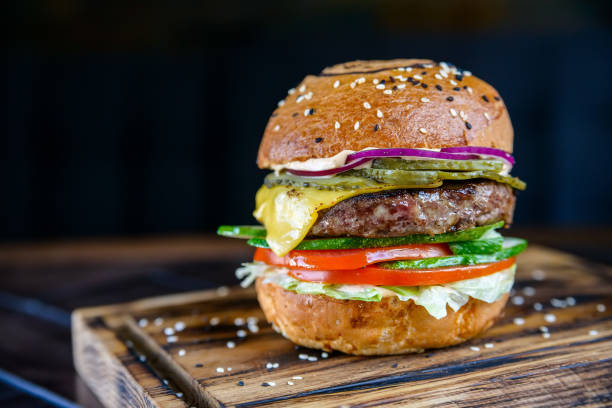 istock Close up delicious fresh burger on wooden board 868959268