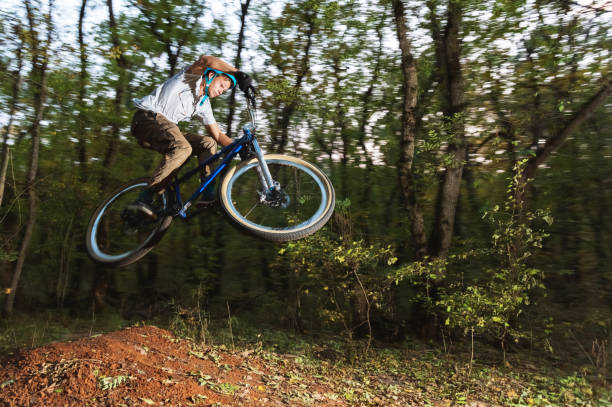 istock a young guy in a helmet flies on a bicycle after jumping from a kicker 868962050