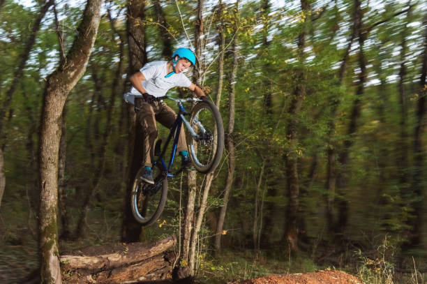 istock a young guy in a helmet flies on a bicycle after jumping from a kicker 868962628