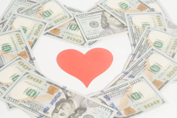 istock Red paper heart and hundred dollar bills for background 868962746