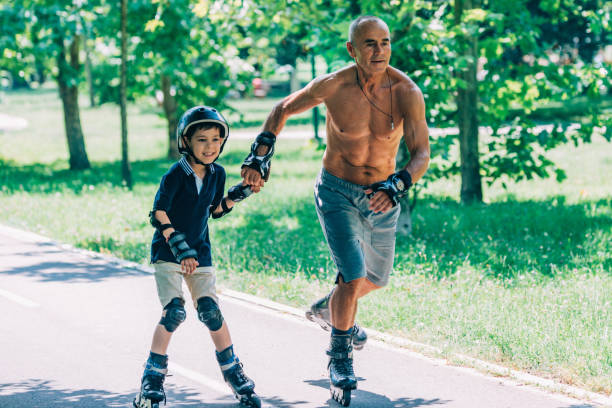 istock Grandfather and grandson roller skating together 868966112