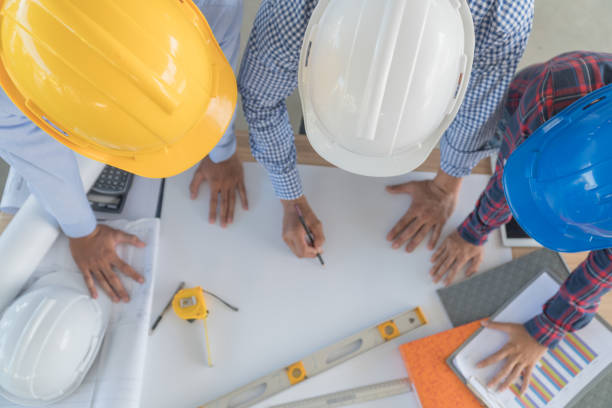 istock The top view of the engineering group is talking. Focus on safety helmet 868966240