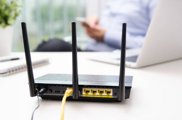 istock Wireless router and man using a smart phone in home 868972222