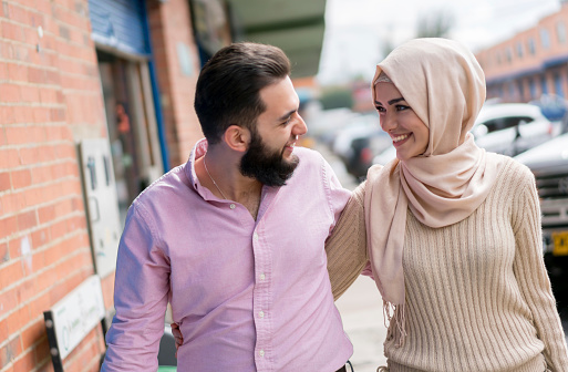 Portrait of a loving young Muslim couple smiling on the street - lifestyle concepts