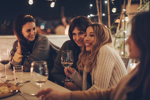 Group of girlfriends spending time together and enjoying in a beautiful evening