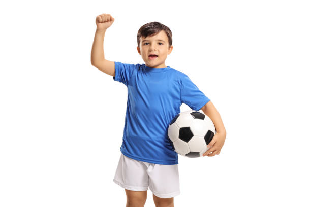 istock Joyful little footballer gesturing with his hand 868973036