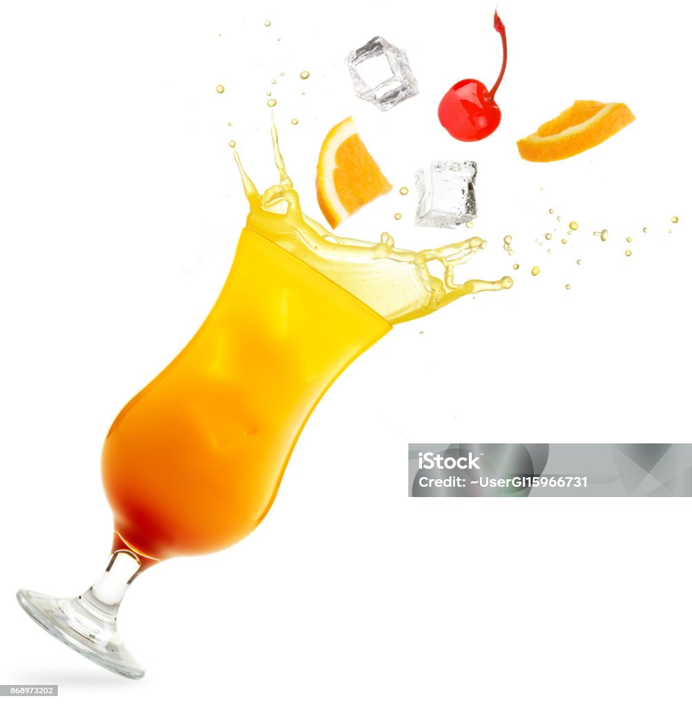 tequila sunrise cocktail splashing isolated on white fruit falling in a tilted glass of tequila sunrise isolated on white background Cocktail Stock Photo