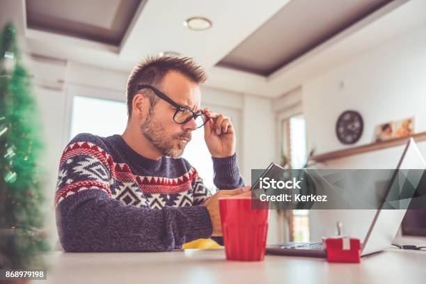 Man Using Smart Phone At Home Stock Photo - Download Image Now - Winter, Sadness, Shopping