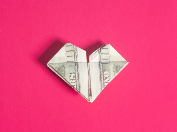 Dollar US bills in heart shape origami Dollar US bills in heart shape origami making money origami stock pictures, royalty-free photos & images