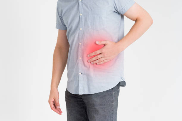 istock Man with abdominal pain, stomach ache on gray background 868979800