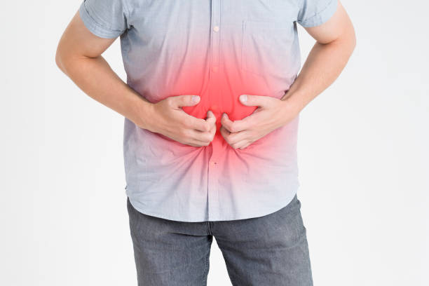 istock Man with abdominal pain, stomach ache on gray background 868982420