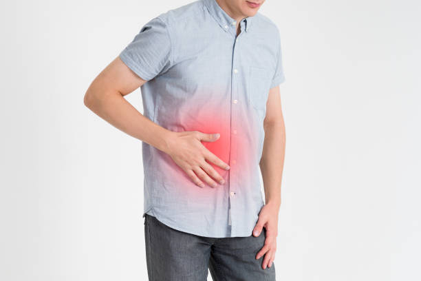 istock Man with abdominal pain, stomach ache on gray background 868983070