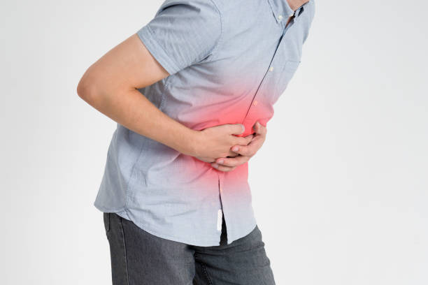 istock Man with abdominal pain, stomach ache on gray background 868983454