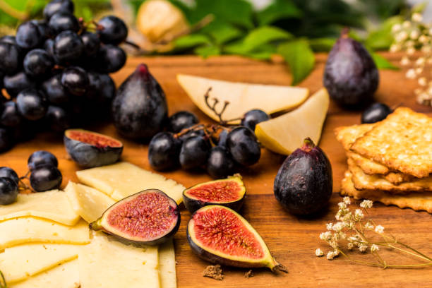 Food still life with cheese, grapes and figs