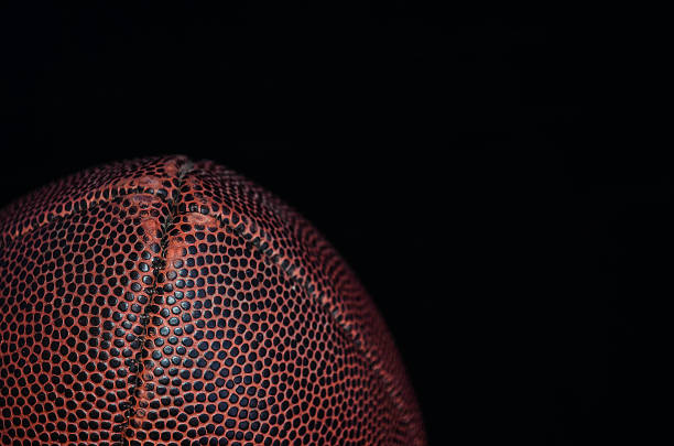 Brown ball for football in the black background. Close up Brown ball for football in the black background. Close up the black ball stock pictures, royalty-free photos & images