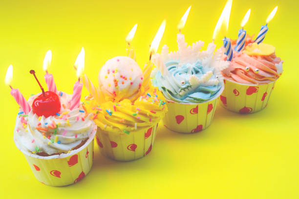 Birthday cupcake with candles on color background
