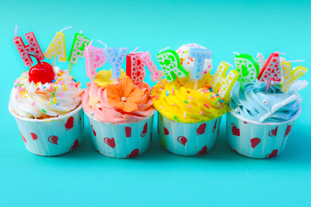 istock Birthday cupcake with candles on color background 869008098
