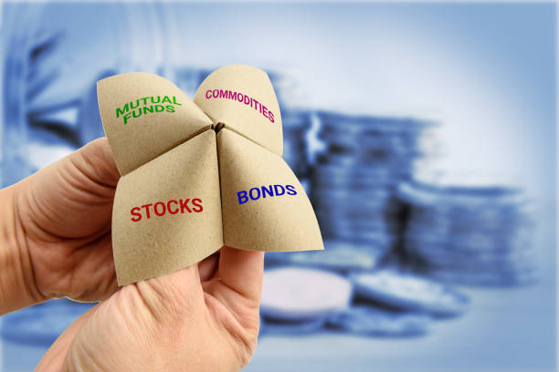 Man uses a paper fortune teller to make multiple decisions for his own portfolio. Man uses a paper fortune teller to make multiple decisions for his own portfolio, allocating assets and diversifying in a portfolio to minimize risk for optimal profits. Financial investment concept. allocate stock pictures, royalty-free photos & images