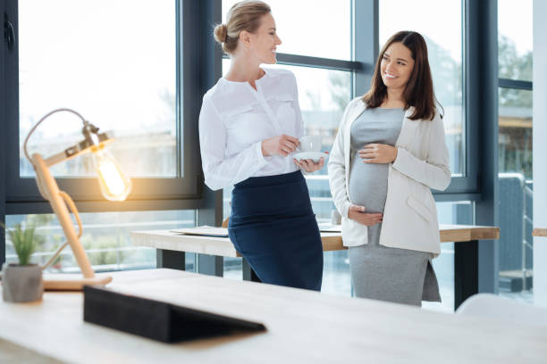 istock Pleased coworkers talking in the office 869014502