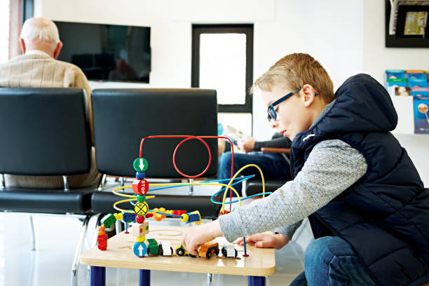istock Young boy playing in waiting room at the clinic 869016024