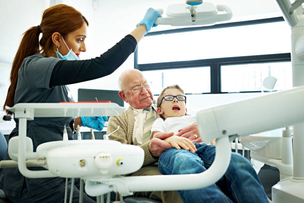 istock Young boy with his grandfather for a dental check-up 869016228