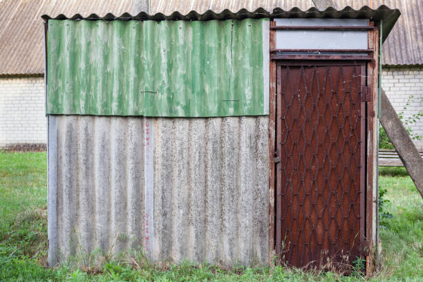 istock Old weathered barn with metal door. 869022106