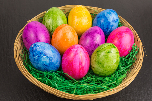 colorful painted easter eggs in a basket