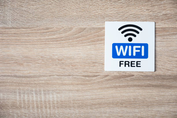 istock free WiFi sign on the wooden wall with space for adding text on the left side and under 869026036