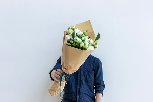 guy holding white flower bouquet