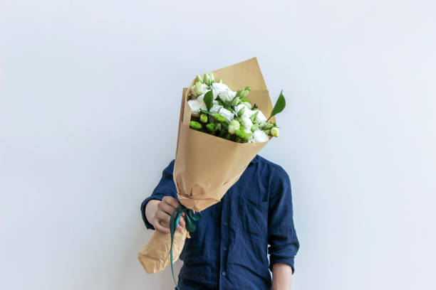 guy holding white flower bouquet guy holding white flower bouquet man flower stock pictures, royalty-free photos & images