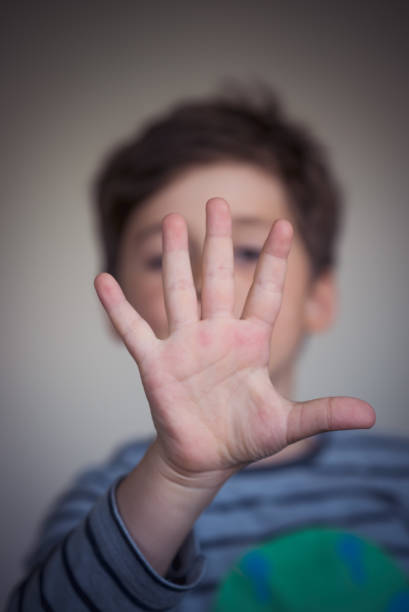 istock Boy showing five with his fingers. 869040680