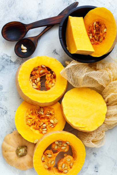 istock Ripe pumpkin sliced and wooden spoons. 869044850