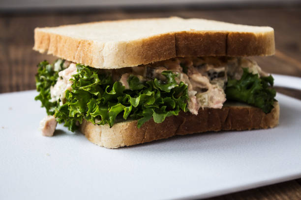 istock tuna pickles sandwich with salad on white plate 869049792