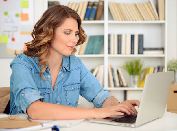 istock blonde woman working in the office 869054216