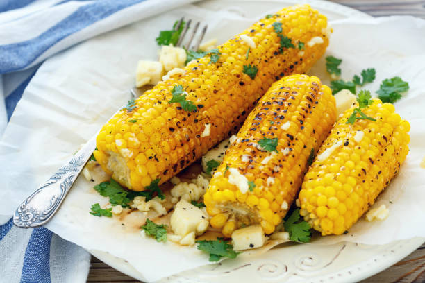 istock Grilled corn with butter, cheese and cilantro. 869054560