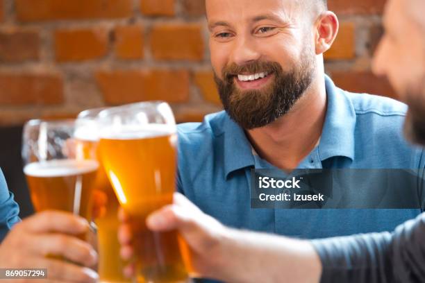 Friends Drinking Beer In The Pub Stock Photo - Download Image Now - 35-39 Years, Adult, Adults Only