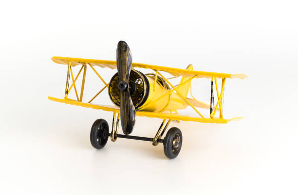 istock Vintage Yellow metal toy plane isolated on white 869065178