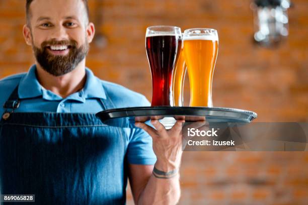 Happy Bartender Holding Serving Tray With Glasses Of Beer Stock Photo - Download Image Now