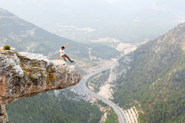 istock Mountain Man Success Concept on high Rock 869070216