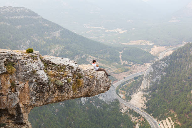 istock Mountain Man Success Concept on high Rock 869070218