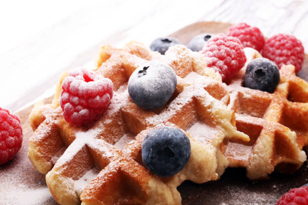 istock Traditional belgian waffles with fresh blueberries, sugar and raspberries 869070520
