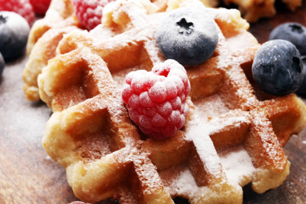 istock Traditional belgian waffles with fresh blueberries, sugar and raspberries 869070732