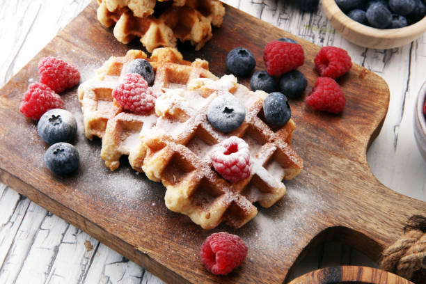 istock Traditional belgian waffles with fresh blueberries, sugar and raspberries 869070920