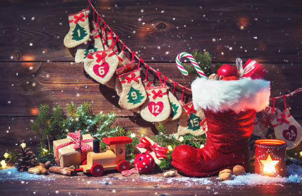 Advent calendar and Santa's shoe with gifts on rustic wooden background Christmas background. Advent calendar and Santa's shoe with gifts on rustic wooden background christmas ornament christmas decoration red religious celebration stock pictures, royalty-free photos & images