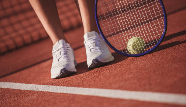 istock Girl playing tennis 869078174