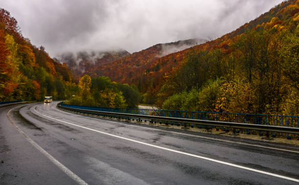 istock curve road through mountains on autumn rainy day 869080536